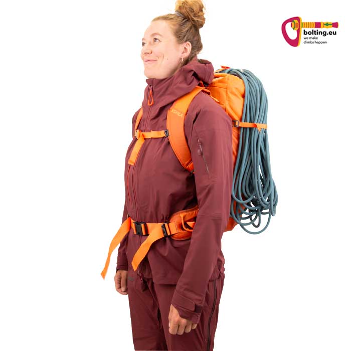 Modell mit lila BEkleidung und orangem Kohla Alpinrucksack Alpnist Pro.